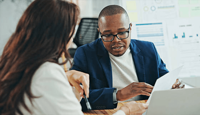 Two people working together at desk