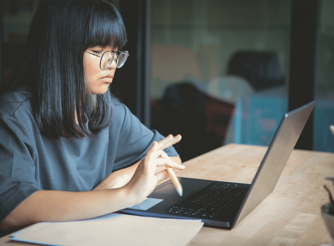 Female working on laptop making notes